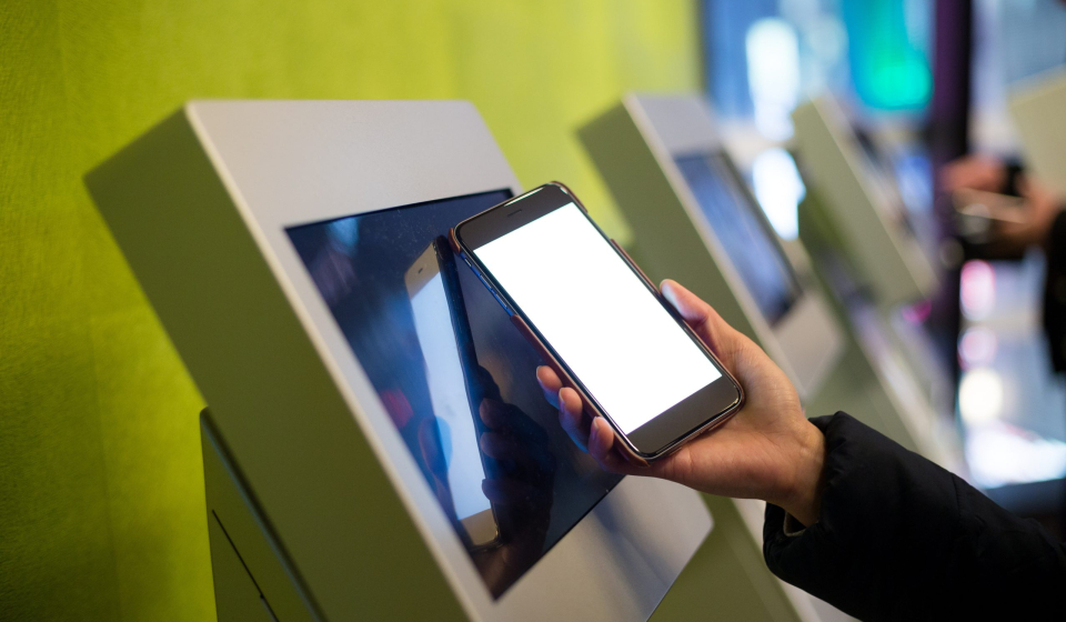 Woman using the ticketing system by cellphone with NFC technology